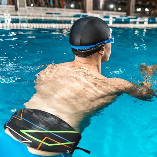 Person swimming in a pool with goggles and swim cap