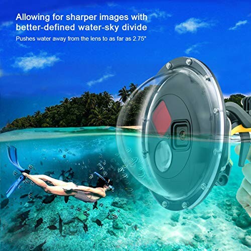 Underwater camera dome lens capturing clear water-sky divide with a snorkeler and fish